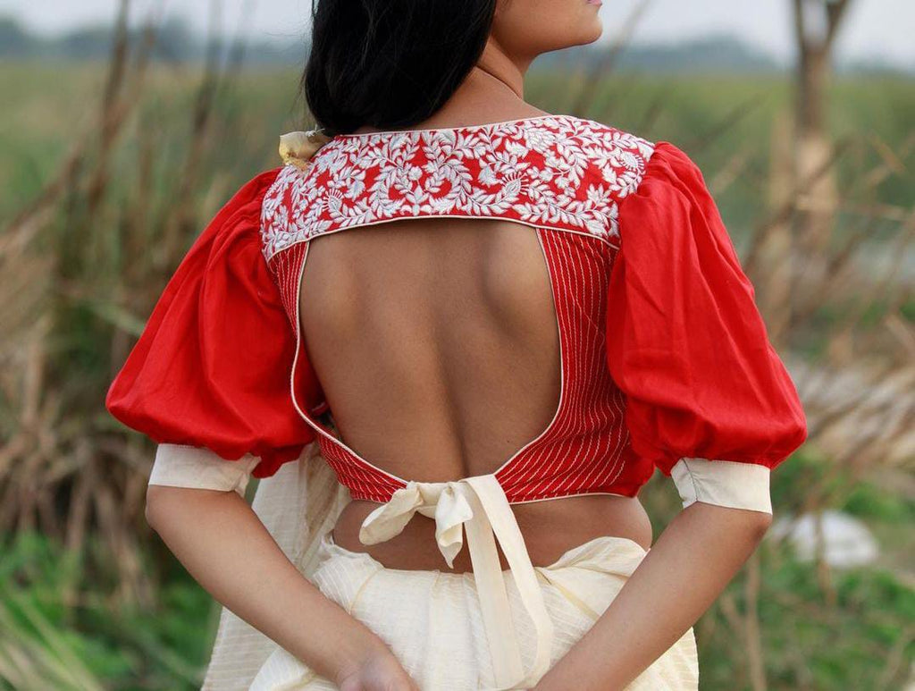 Red boat neck blouse with white embroidered detailing