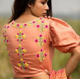 Peach boat neck blouse with floral embroidered detailing
