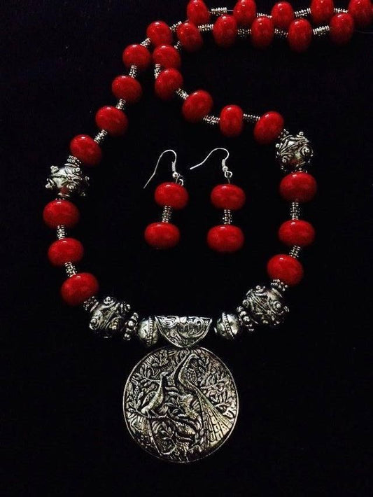 Rounded Red Beads with German Silver Heavy Beads and Peacock Pendant - Dailybuyys